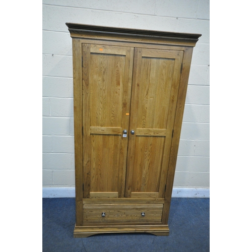 1331 - A SOLID OAK WARDROBE, with two doors over two drawers , width 93cm x depth 60cm x  height 181cm (con... 