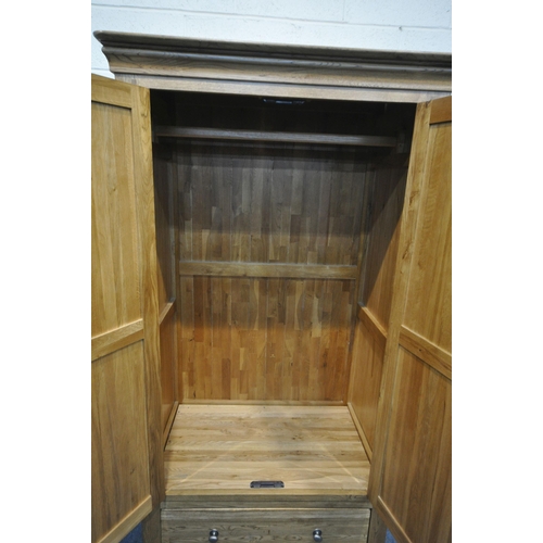 1331 - A SOLID OAK WARDROBE, with two doors over two drawers , width 93cm x depth 60cm x  height 181cm (con... 