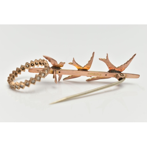 63 - A EARLY 20TH CENTURY 9CT GOLD BROOCH, a yellow gold bar brooch designed with three swallows, set wit... 