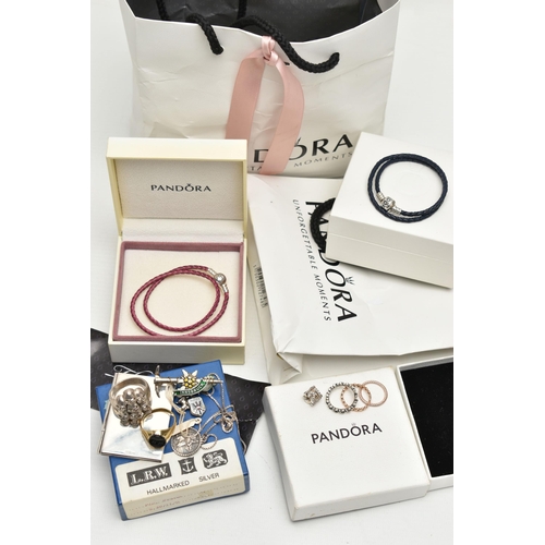 79 - TWO PANDORA BRACELETS AND OTHER ITEMS, to include a boxed pink cord bracelet fitted with a signed 'P... 