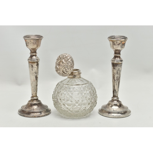 154 - A PAIR OF ELIZABETH II SILVER CANDLESTICKS AND AN EDWARDIAN SILVER MOUNTED GLASS SCENT BOTTLE, the c... 