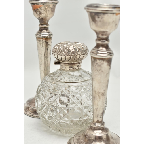 154 - A PAIR OF ELIZABETH II SILVER CANDLESTICKS AND AN EDWARDIAN SILVER MOUNTED GLASS SCENT BOTTLE, the c... 