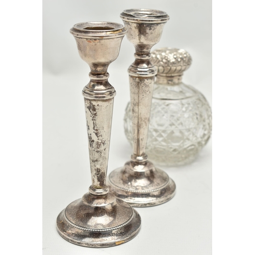 154 - A PAIR OF ELIZABETH II SILVER CANDLESTICKS AND AN EDWARDIAN SILVER MOUNTED GLASS SCENT BOTTLE, the c... 