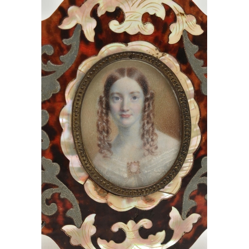 160 - A VICTORIAN HEAD AND SHOULDERS IVORY PORTRAIT MINIATURE OF A YOUNG WOMAN, her brown hair in ringlets... 