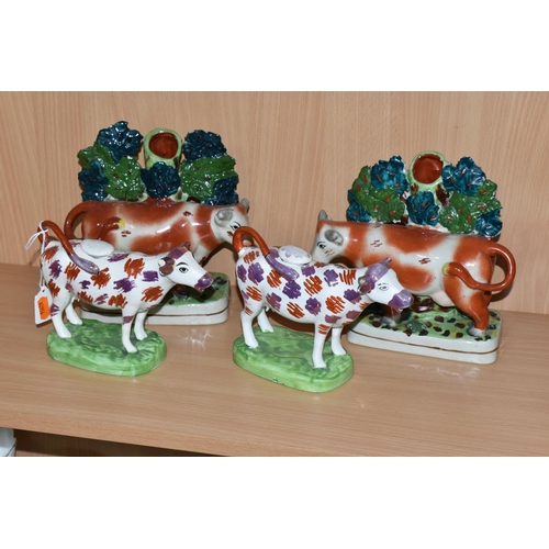 378 - FOUR PIECES OF COW THEMED POTTERY, comprising two cow creamers with red and pink lustre patches, sta... 