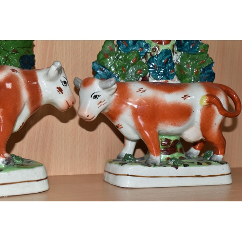 378 - FOUR PIECES OF COW THEMED POTTERY, comprising two cow creamers with red and pink lustre patches, sta... 