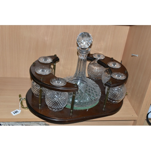 381 - A CUT GLASS SHIPS DECANTER AND SIX BRANDY GLASSES IN A WOODEN STAND (1) (Condition Report: some scra... 