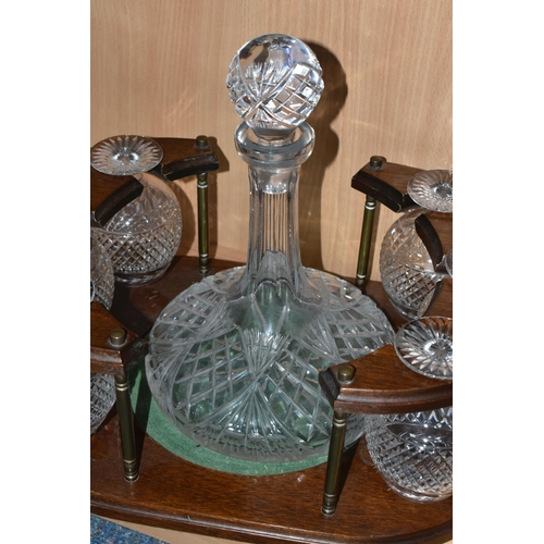 381 - A CUT GLASS SHIPS DECANTER AND SIX BRANDY GLASSES IN A WOODEN STAND (1) (Condition Report: some scra... 