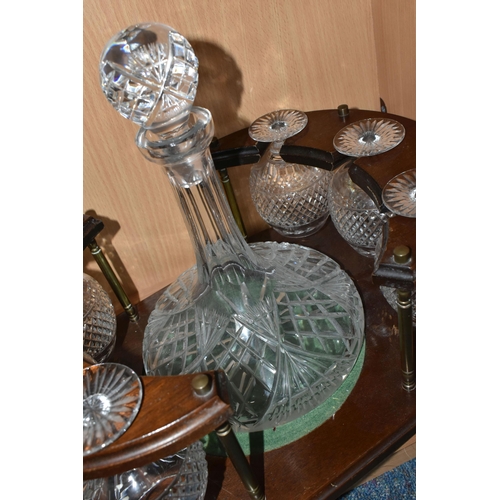 381 - A CUT GLASS SHIPS DECANTER AND SIX BRANDY GLASSES IN A WOODEN STAND (1) (Condition Report: some scra... 