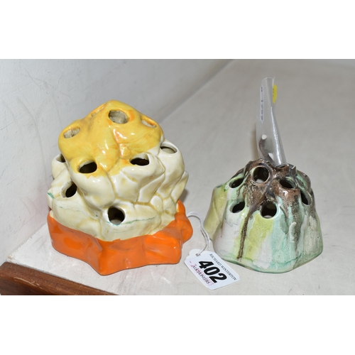 402 - TWO CLARICE CLIFF FLORAL FROGS, of naturalistic form, the larger 'Fantasque' frog having yellow and ... 