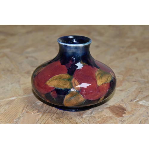 453 - A MOORCROFT POTTERY 'POMEGRANATE' VASE, of squat form, tube lined Pomegranate pattern on a navy blue... 