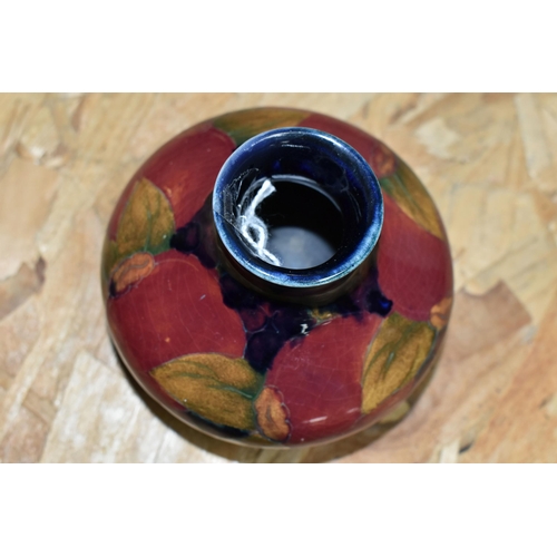 453 - A MOORCROFT POTTERY 'POMEGRANATE' VASE, of squat form, tube lined Pomegranate pattern on a navy blue... 