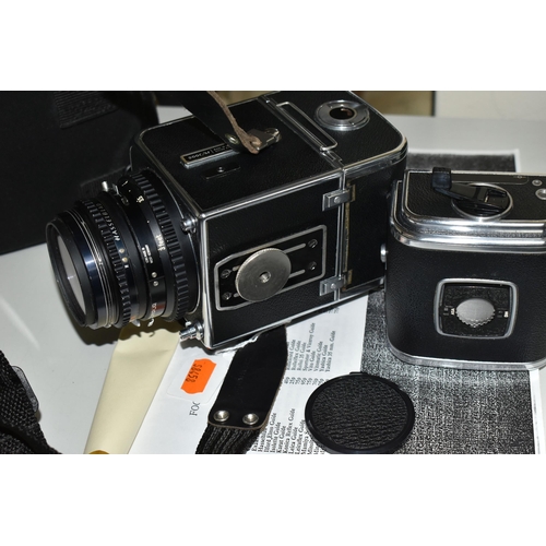 483 - A HASSELBLAD 500C/M MEDIUM FORMAT FILM CAMERA fitted with a Carl Zeiss Planar 80mm f2.8 lens, two fi... 