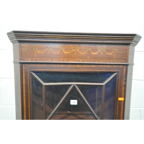 1196 - AN EDWARDIAN MAHOGANY AND MARQUETRY INLAID ASTRAGAL GLAZED SINGLE DOOR CORNER CUPBOARD, enclosing th... 