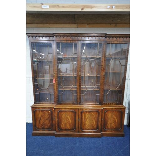 1204 - A REPRODUX  MAHOGANY BREAKFRONT BOOKCASE, with four astragal glazed doors that's enclosing adjustabl... 