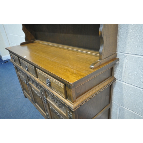 1224 - AN OLD CHARM OAK DRESSER, with three draws over three linenfold cupboard doors, width 135cm x depth ... 