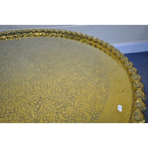 1233 - A LARGE ANGLO INDIAN BRASS TOP COFFEE TABLE, decorated with foliate detail surrounded  by moulded ed... 