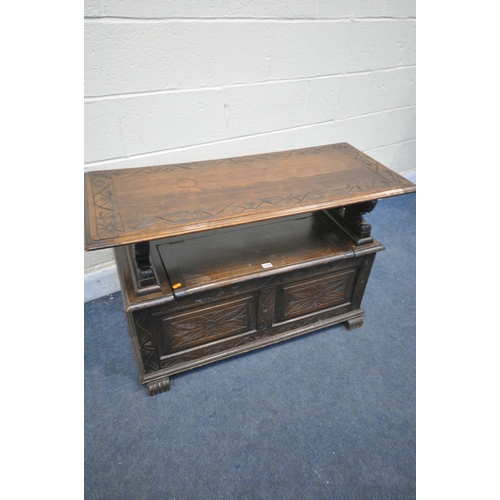 1235 - A 20TH CENTURY MONKS BENCH, lifting lid supported by lion mask uprights, surrounding storage compart... 