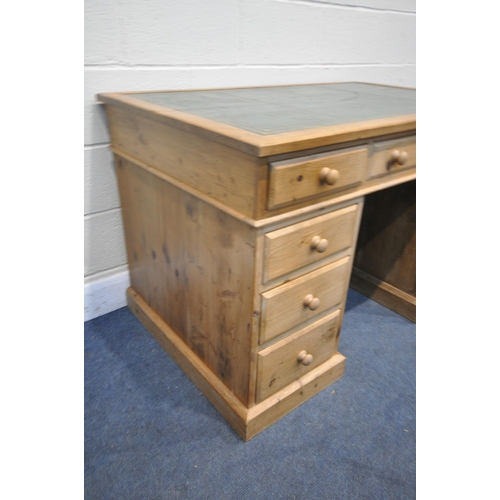 1254 - A PINE PEDASTAL DESK, with a green leather and gilt tooled writing surface and nine drawers, width x... 