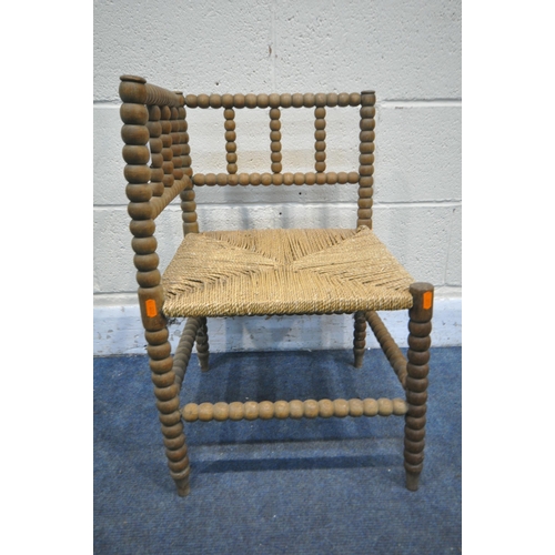 1262 - A WILLIAM MORRIS STYLE BEECH BOBBIN TURNED CORNER CHAIR, with a rush seat (condition:- worn finish, ... 