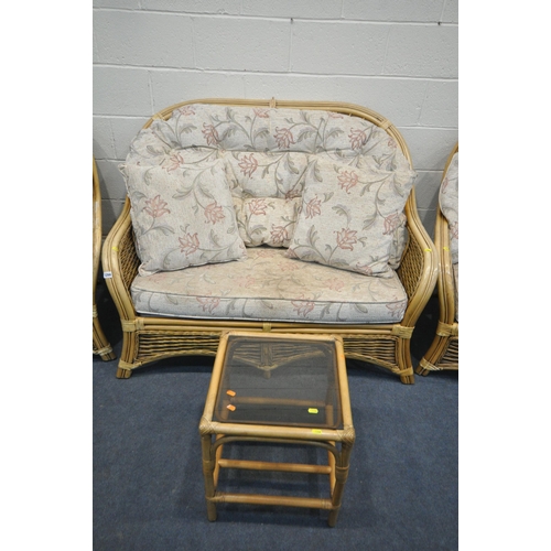 1266 - A WICKER CONSERVATORY SUITE, comprising  a sofa, two armchairs, pouffe, and a coffee table (conditio... 