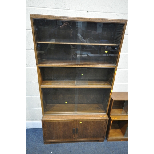 1277 - A 20TH CENTURY MINTY OAK SECTIONAL BOOKCASE, with sliding glazed doors and double cupboard doors wid... 