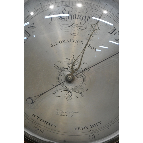 1296 - A GEORGE III FLAME MAHOGANY WHEEL BAROMETER, convex glass enclosing the dial  signed Joseph Somalvic... 