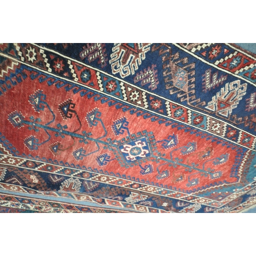 1320 - TWO SIMILAR PERSIAN KAZAK RUGS, made up of red and blue fields largest rug measurement  214cm x 125c... 