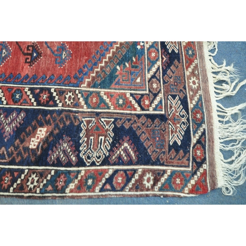 1320 - TWO SIMILAR PERSIAN KAZAK RUGS, made up of red and blue fields largest rug measurement  214cm x 125c... 