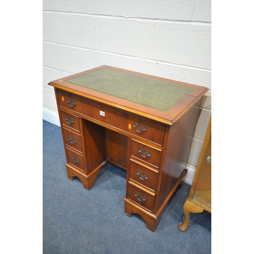 1330 - A YEW WOOD KNEE HOLE DESK, with a green leather writing surface and seven drawers, width 77cm x dept... 