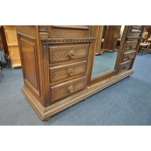 1334 - AN EARLY 20TH CENTURY HAMPTON AND SONS OF PALL MALL EAST LONDON, CARVED OAK COMPACTUM WARDROBE, comp... 