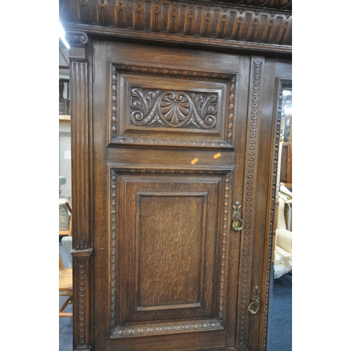 1334 - AN EARLY 20TH CENTURY HAMPTON AND SONS OF PALL MALL EAST LONDON, CARVED OAK COMPACTUM WARDROBE, comp... 