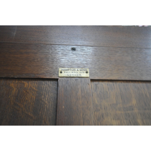 1334 - AN EARLY 20TH CENTURY HAMPTON AND SONS OF PALL MALL EAST LONDON, CARVED OAK COMPACTUM WARDROBE, comp... 