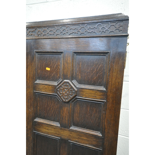 1335 - AN EARLY 20TH CENTURY MAPLE AND CO OF LONDON, OAK TWO DOOR HALL ROBE/CUPBOARD, enclosing a shelf fit... 