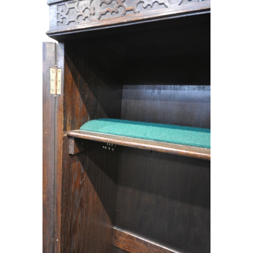 1335 - AN EARLY 20TH CENTURY MAPLE AND CO OF LONDON, OAK TWO DOOR HALL ROBE/CUPBOARD, enclosing a shelf fit... 