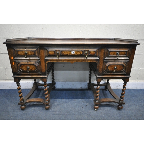 1340 - AN EARLY 20TH CENTURY OAK PEDASTAL SIDEBOARD, with a gallery top over five drawers with brass drop h... 