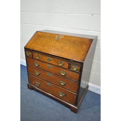 1341 - A GEORGIAN OAK BUREAU, with a fitted interior over six exterior drawers on bracket feet, width 95cm ... 