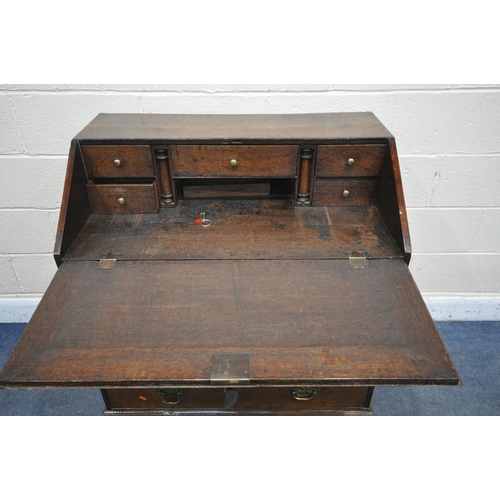 1341 - A GEORGIAN OAK BUREAU, with a fitted interior over six exterior drawers on bracket feet, width 95cm ... 