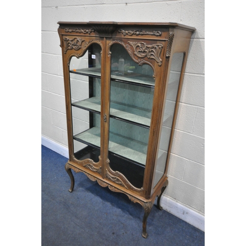 1342 - AN EARLY TO MID CENTURY FRENCH WALNUT TWO DOOR DISPLAY CABINET, enclosing three shelves on cabriole ... 