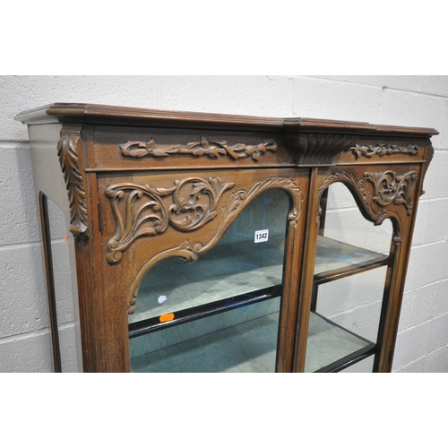 1342 - AN EARLY TO MID CENTURY FRENCH WALNUT TWO DOOR DISPLAY CABINET, enclosing three shelves on cabriole ... 