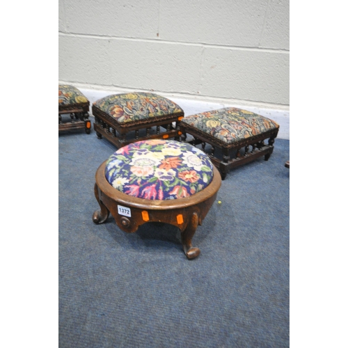 1372 - A VICTORIAN WALNUT FOOTSTOOL, on triple cabriole legs, along with three matching Edwardian footstool... 