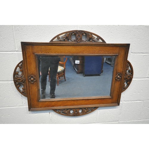 1384 - AN EARLY 20TH CENTURY OAK FRAMED RECTANGULAR WALL MIRROR, with a half circle foliate open fretwork d... 