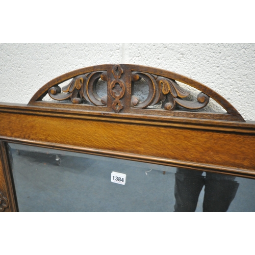 1384 - AN EARLY 20TH CENTURY OAK FRAMED RECTANGULAR WALL MIRROR, with a half circle foliate open fretwork d... 