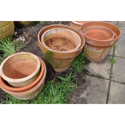 1005 - A COLLECTION OF TEN WEATHERED TERRACOTTA POTS of all different sizes largest pot diameter 43cm (10)