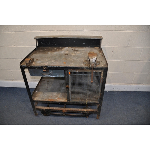 1090 - A METAL WORKBENCH on a wheeled base, lever to the rear with lifting mechanism, two vices, a Woden an... 