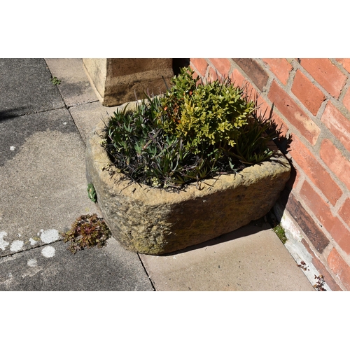 961 - A VINTAGE SANDSTONE TROUGH with one curved end width 43cm depth 54cm  height 28cm with soil and plan... 