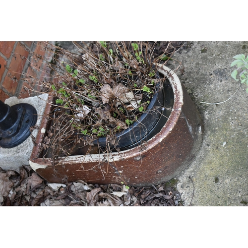 972 - A VINTAGE TREACLE GLAZED TROUGH with one curved end depth 57cm, a vintage water pump and a stone blo... 