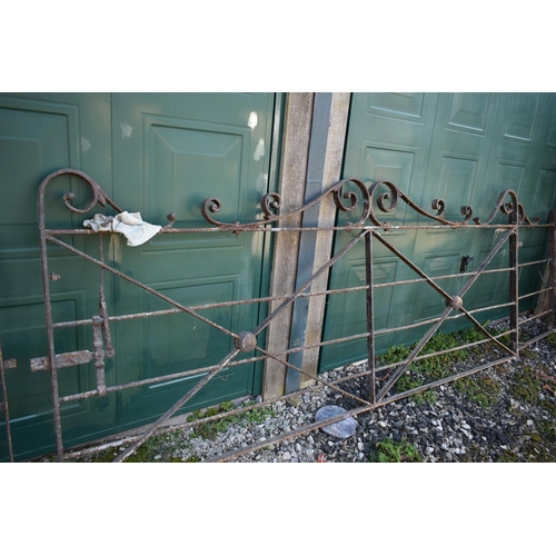 989 - A SET OF LARGE VINTAGE GATES including a 310cm wide gate with scrolled pedaments, x braced with latc... 