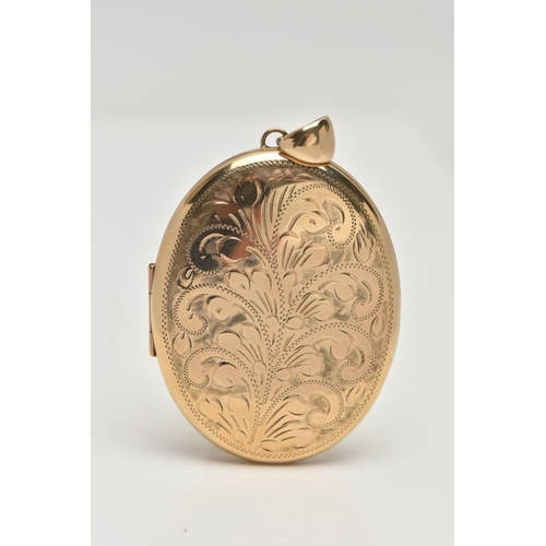 110 - A LARGE OVAL LOCKET, floral design to the front, opens to reveal two photo compartments, approximate... 