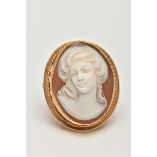 112 - A LARGE 9CT GOLD CAMEO DRESS RING, oval shell cameo depicting a lady, collet set with a fine rope tw... 